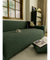 Rhona green stretch sofa cover fitted over a three seater sofa