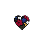 Latimer heart shaped embroidered cushion with colourful floral tufting on black fabric