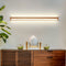 Hadleigh linear wood LED wall light mounted above a wooden sideboard
