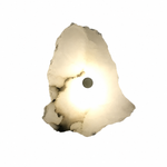 Mortimer organic marble wall light glowing softly against a white wall