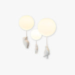 Yorick bear and balloon LED ceiling light glowing against a white wall