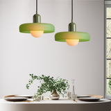 Bevan colourful glass disc pendant light hanging above a dining table