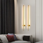 Ludlow gold linear LED wall lights mounted above a sofa in a modern living space