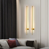 Ludlow gold linear LED wall lights mounted above a sofa in a modern living space